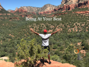 Man facing red rock scene in Sedona, with this arms outstretched.